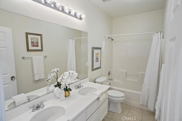 full bath featuring tile patterned flooring, toilet, shower / tub combo with curtain, and a sink