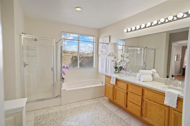 bathroom featuring a sink, a stall shower, a garden tub, and double vanity