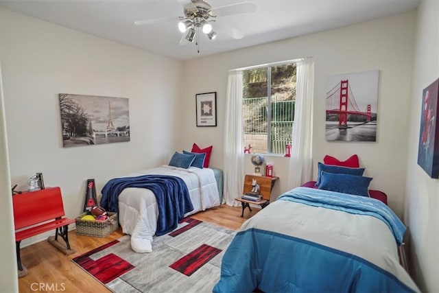 bedroom with a ceiling fan and wood finished floors