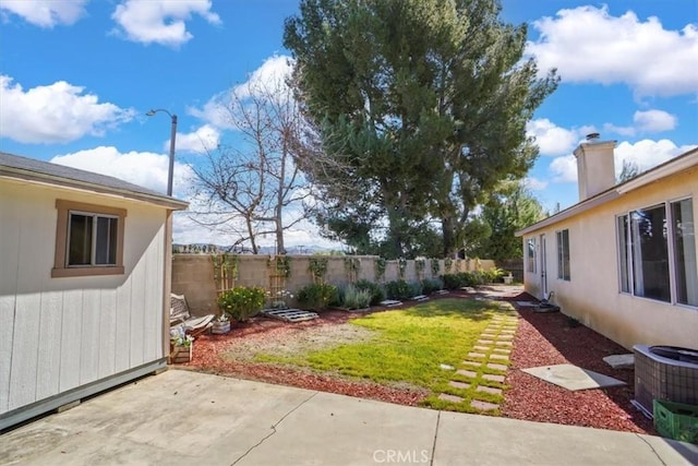 view of yard with a patio, central AC unit, and a fenced backyard