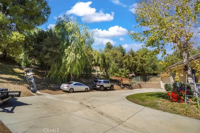 view of vehicle parking with a garage and driveway