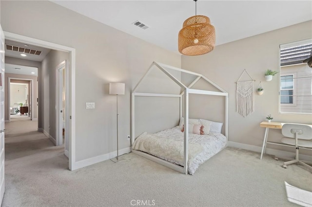 carpeted bedroom with visible vents and baseboards