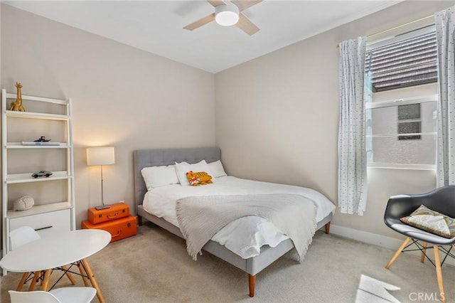 carpeted bedroom with baseboards and ceiling fan