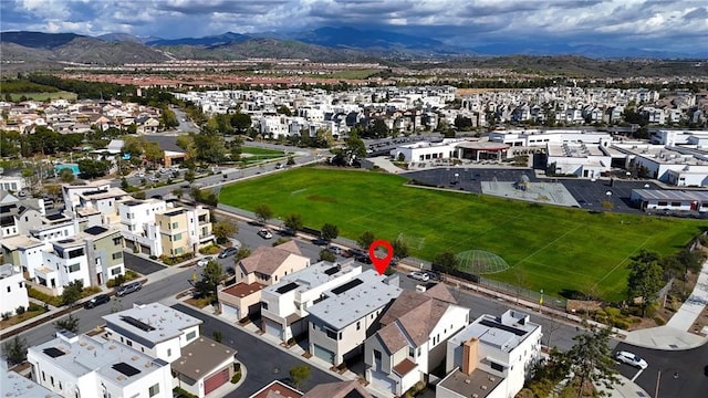 birds eye view of property featuring a mountain view and a residential view