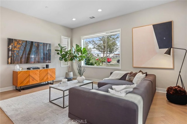 living room featuring recessed lighting, visible vents, and baseboards