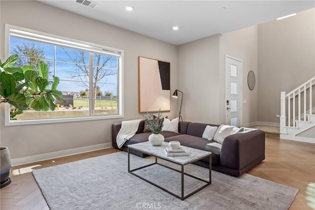 living area featuring recessed lighting, stairway, visible vents, and baseboards