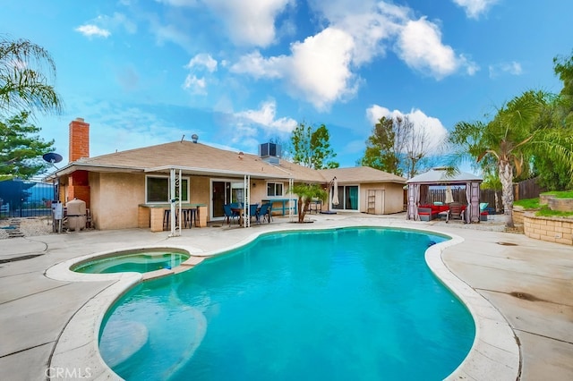 view of swimming pool featuring a gazebo, a patio area, a pool with connected hot tub, and fence