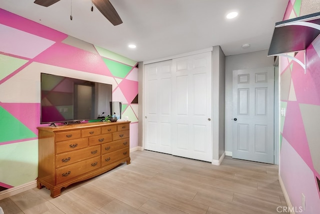 bedroom with recessed lighting, a closet, baseboards, and light wood-style floors