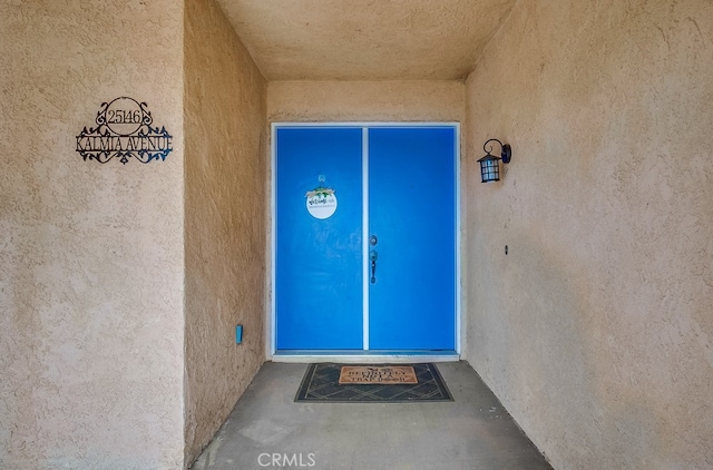 doorway to property with stucco siding