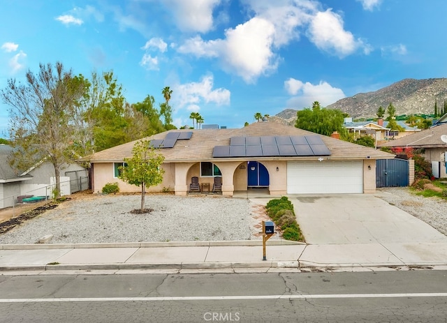 view of front of house with an attached garage, fence, driveway, and stucco siding