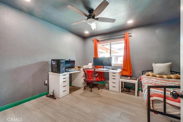 home office with baseboards, a textured ceiling, a ceiling fan, and a textured wall