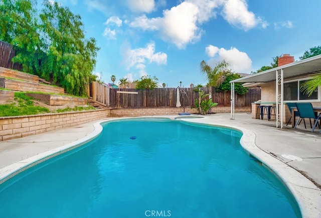 view of pool with a patio, a fenced in pool, and a fenced backyard