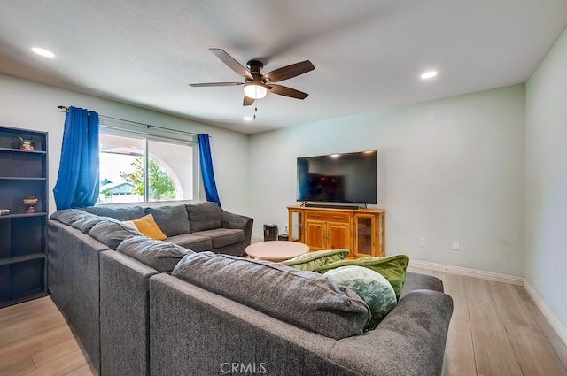 living room with recessed lighting, baseboards, and light wood finished floors