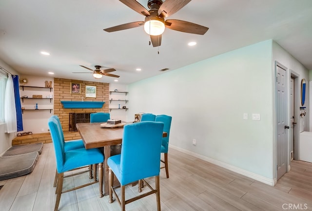 dining area featuring a fireplace, recessed lighting, baseboards, and wood finish floors