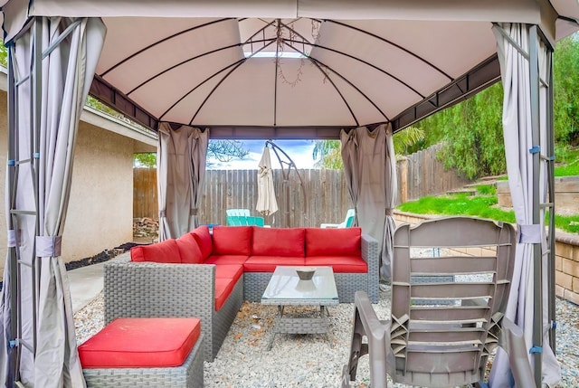 view of patio / terrace with a gazebo, fence, and an outdoor hangout area