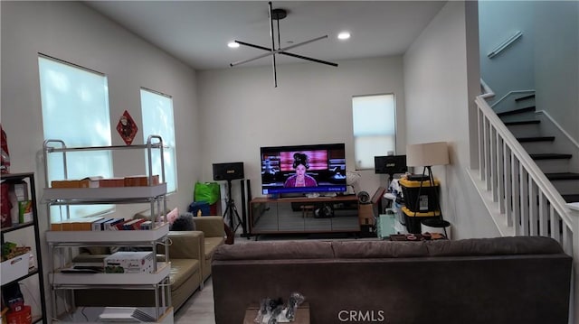 living area with recessed lighting, stairway, and a chandelier