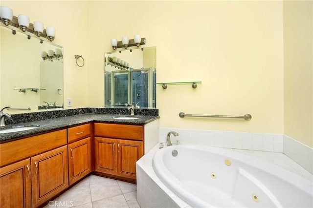 full bathroom with tile patterned floors, a whirlpool tub, a stall shower, and a sink