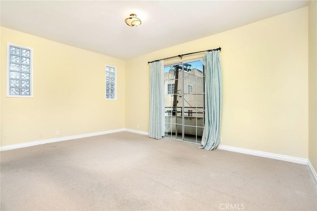 carpeted empty room with baseboards