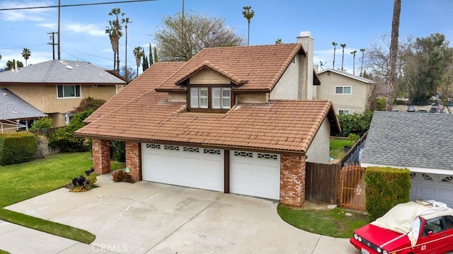 view of front of home with fence, a front yard, brick siding, a chimney, and a tiled roof