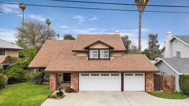 view of front of property featuring a front lawn, an attached garage, brick siding, a chimney, and a tiled roof