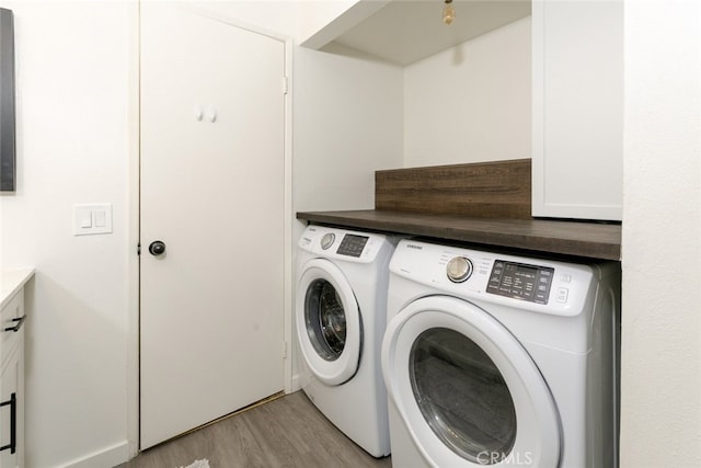 24837 Apple St Unit B, Newhall, CA 91321 - laundry area featuring washing machine and clothes dryer, light wood-type flooring, and cabinet space