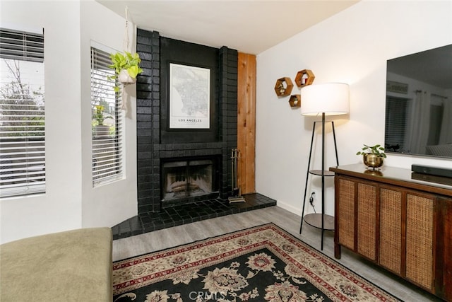 24837 Apple St Unit B, Newhall, CA 91321 - living room featuring wood finished floors and a fireplace