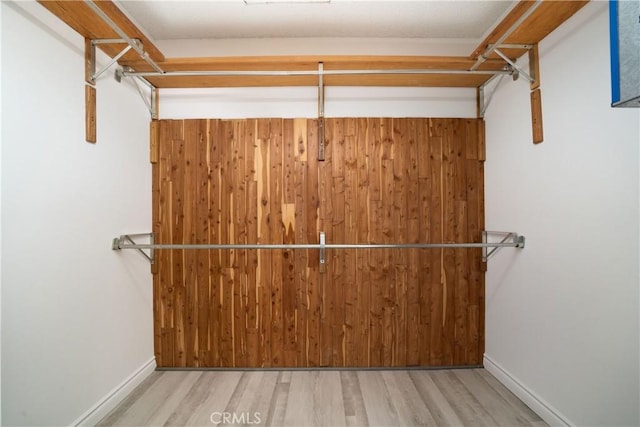 spacious closet with wood finished floors