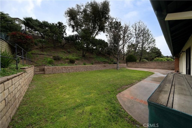 view of yard featuring fence and a patio area