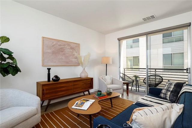 living room with visible vents and wood finished floors