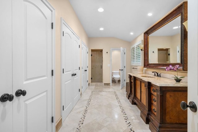 bathroom featuring baseboards, toilet, recessed lighting, a stall shower, and vanity