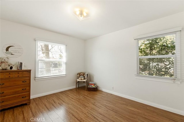 bedroom featuring baseboards and wood finished floors