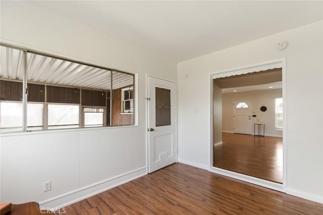 empty room featuring baseboards and wood finished floors