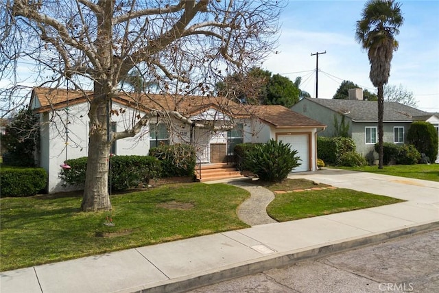 view of front of home with stucco siding, a front yard, concrete driveway, and an attached garage