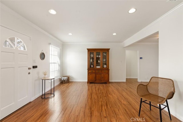 entryway featuring recessed lighting, baseboards, light wood-style flooring, and ornamental molding