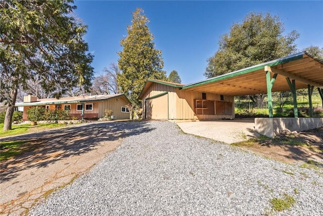 view of front of house with an attached carport and driveway