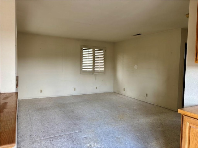 unfurnished room with visible vents