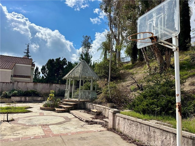 view of patio with a gazebo and fence