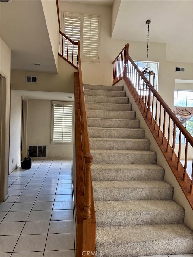 stairway with visible vents and a wealth of natural light