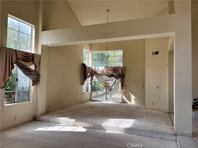 interior space with visible vents, plenty of natural light, and a high ceiling