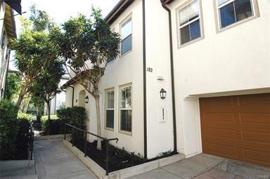 view of side of home with stucco siding and an attached garage