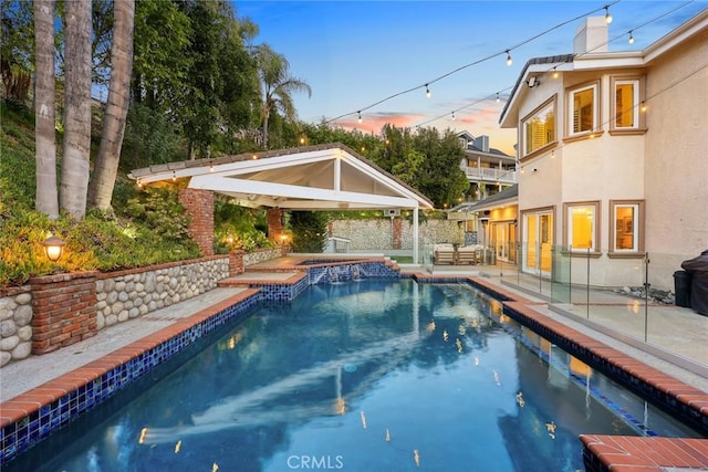 outdoor pool featuring a gazebo, an in ground hot tub, and a patio