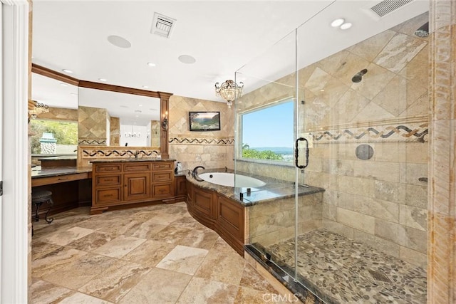 bathroom with a bath, visible vents, a stall shower, and tile walls