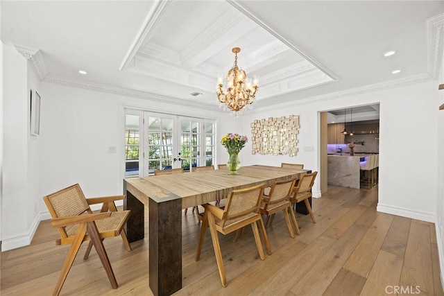 dining area featuring baseboards, an inviting chandelier, french doors, crown molding, and light wood-type flooring