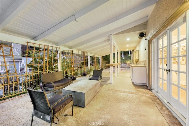 sunroom with lofted ceiling with beams