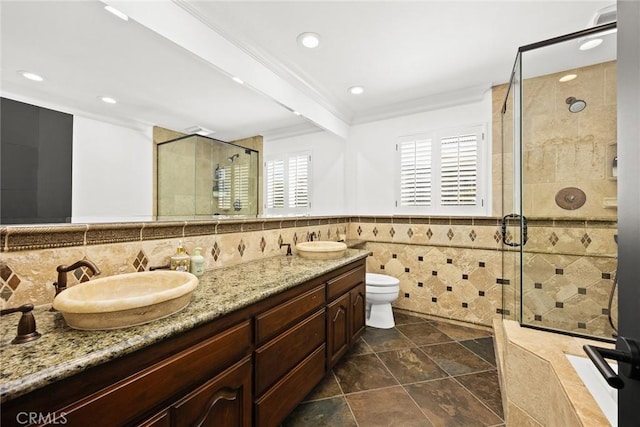 full bathroom featuring a shower stall, tile walls, and a sink