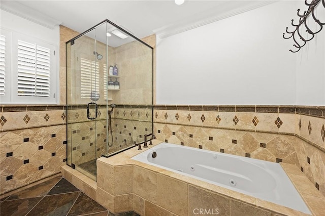 full bathroom featuring tile walls, a tub with jets, a stall shower, and ornamental molding