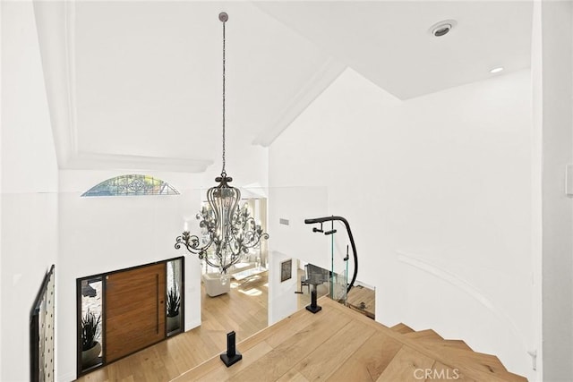 details with a notable chandelier and wood finished floors