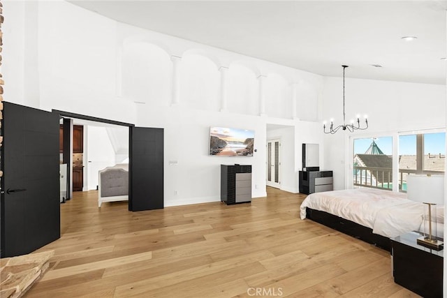 bedroom featuring high vaulted ceiling, light wood-style flooring, an inviting chandelier, baseboards, and access to exterior