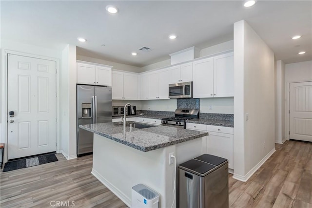 kitchen featuring visible vents, recessed lighting, stainless steel appliances, white cabinetry, and a sink