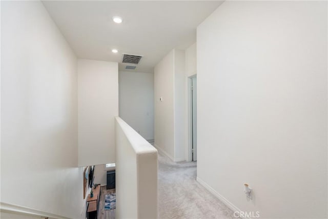 corridor featuring visible vents, an upstairs landing, recessed lighting, baseboards, and light colored carpet